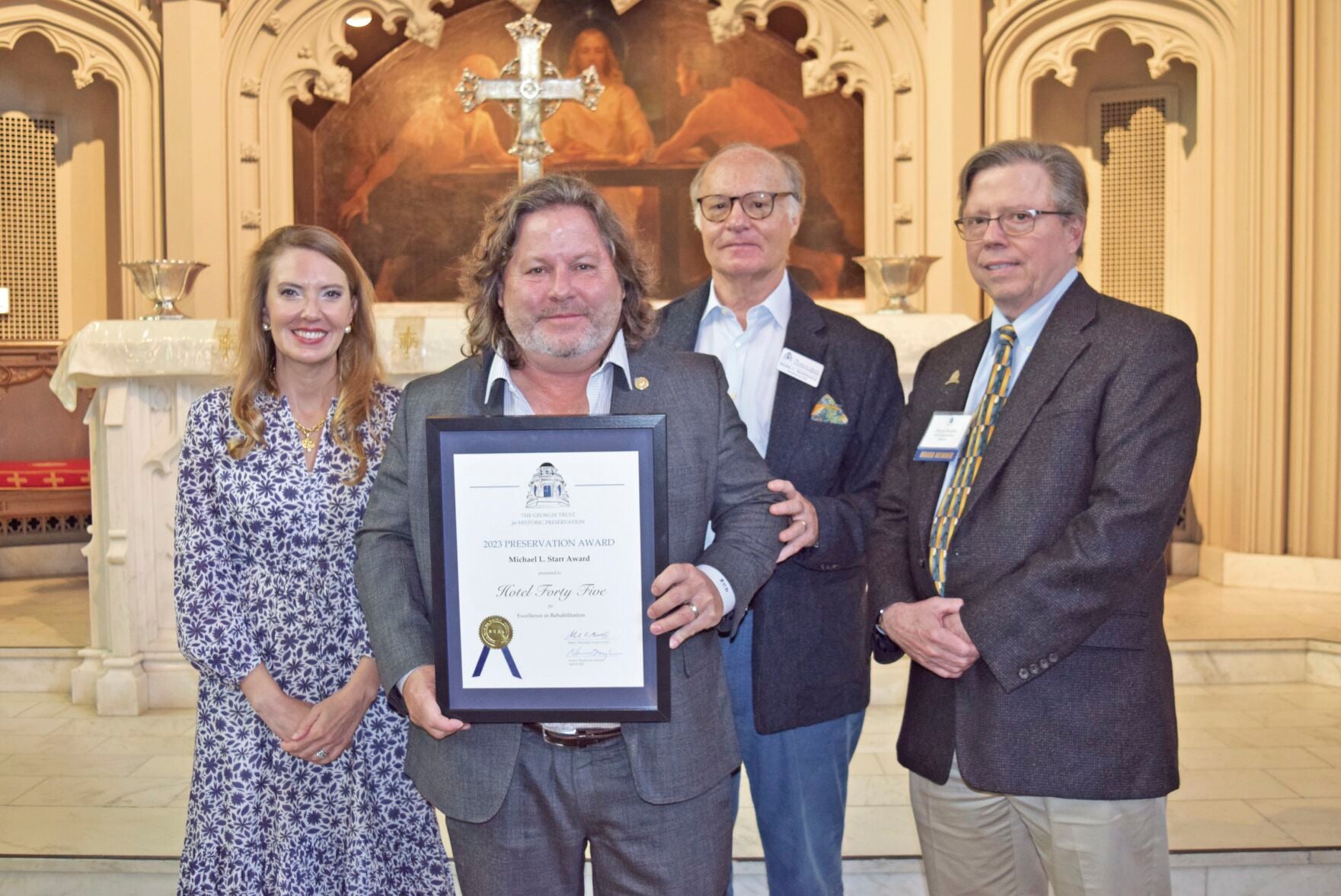 Gene Dunwody holding the 2023 Michael L. Starr Award for Hotel Forty Five with Georgia Trust representatives
