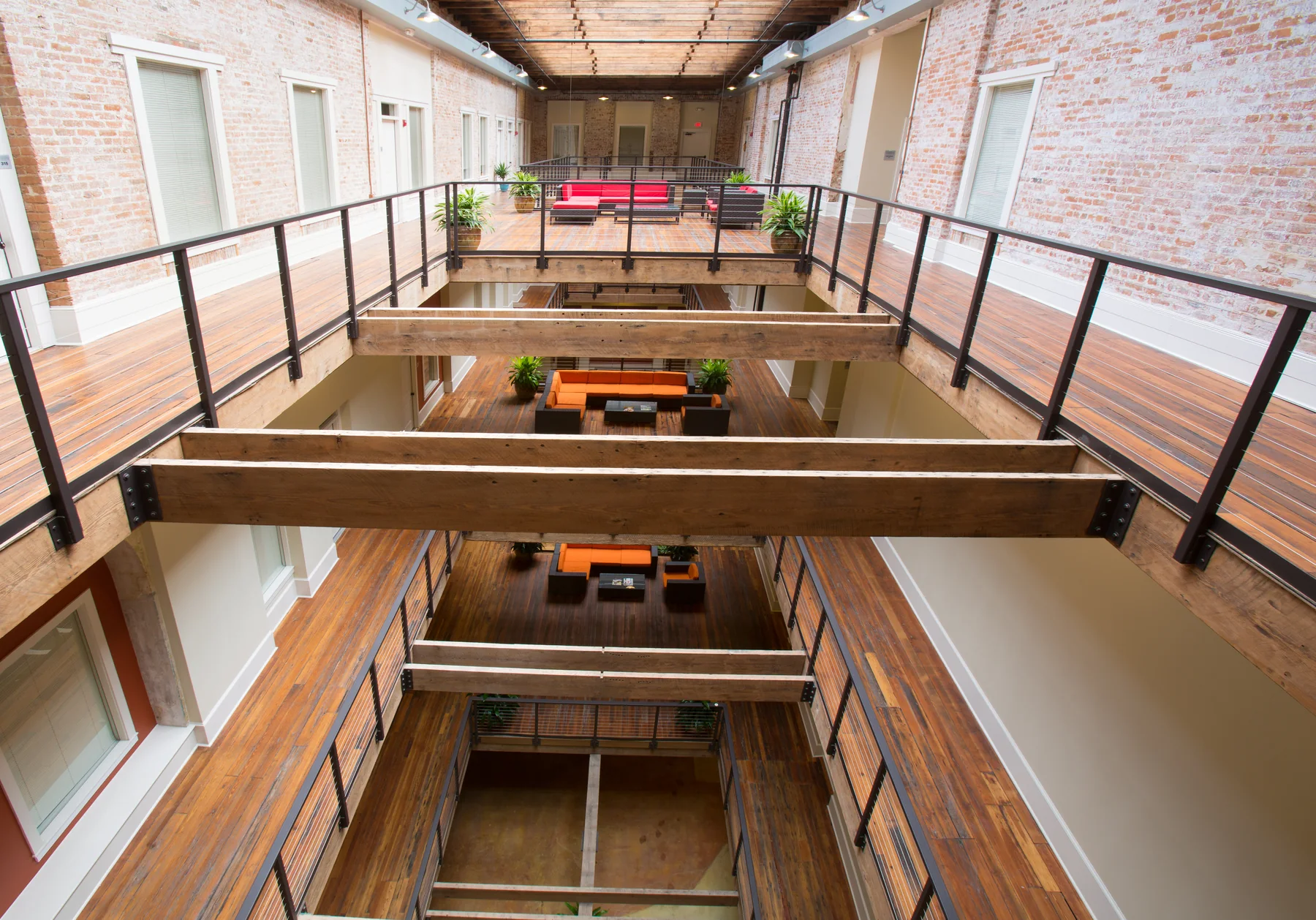 Multi-level timber-and-brick atrium inside a rehabilitated building