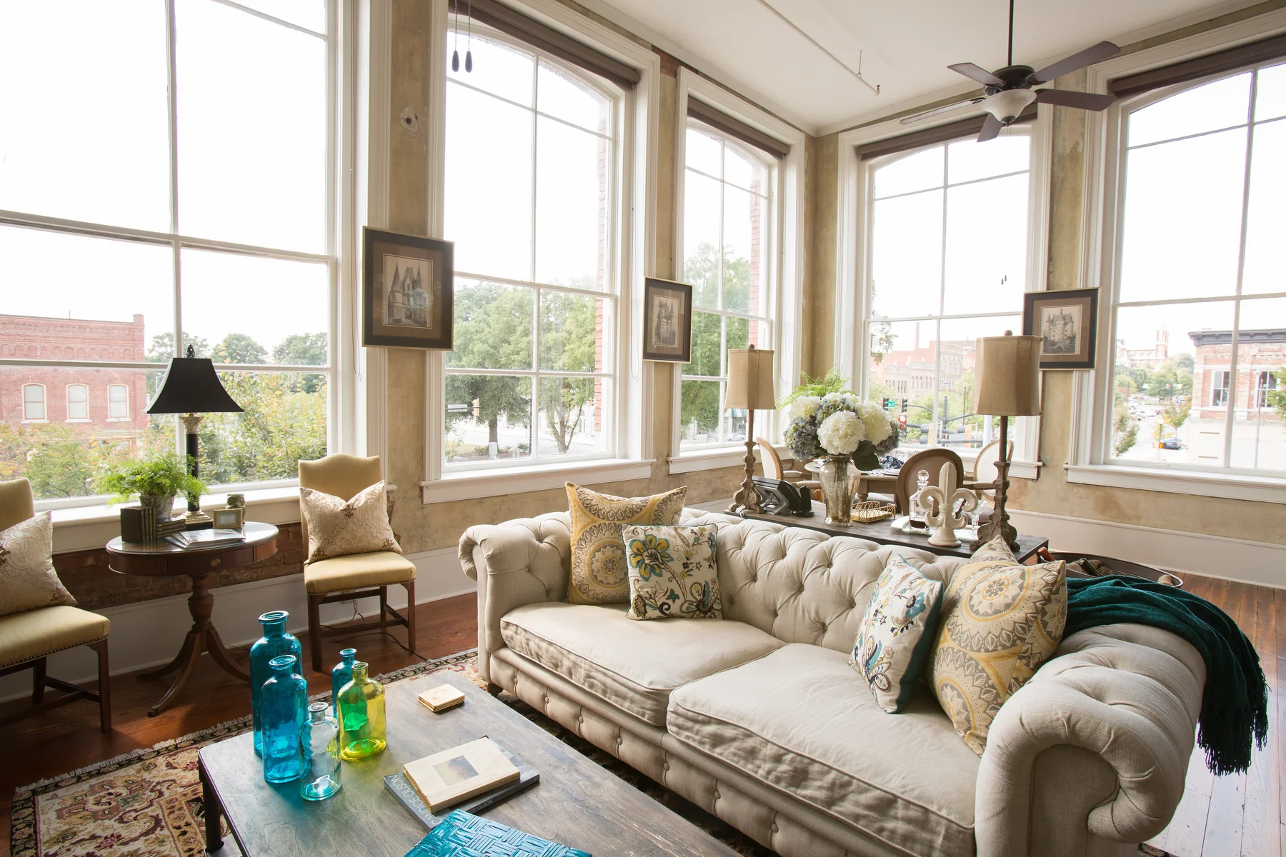 Loft living space with exposed brick and tall windows