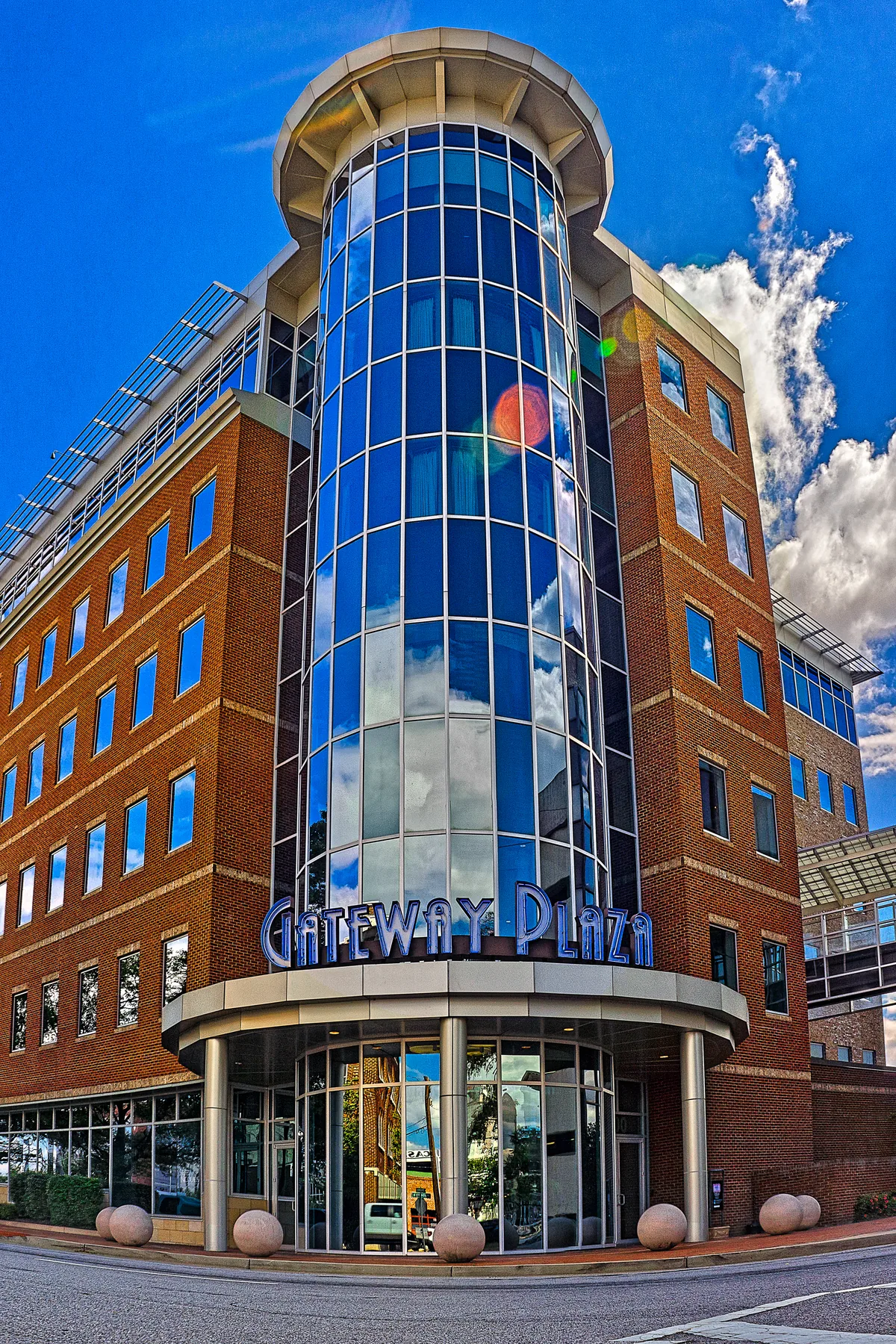 Six-story brick Gateway Plaza office building with a glazed corner tower