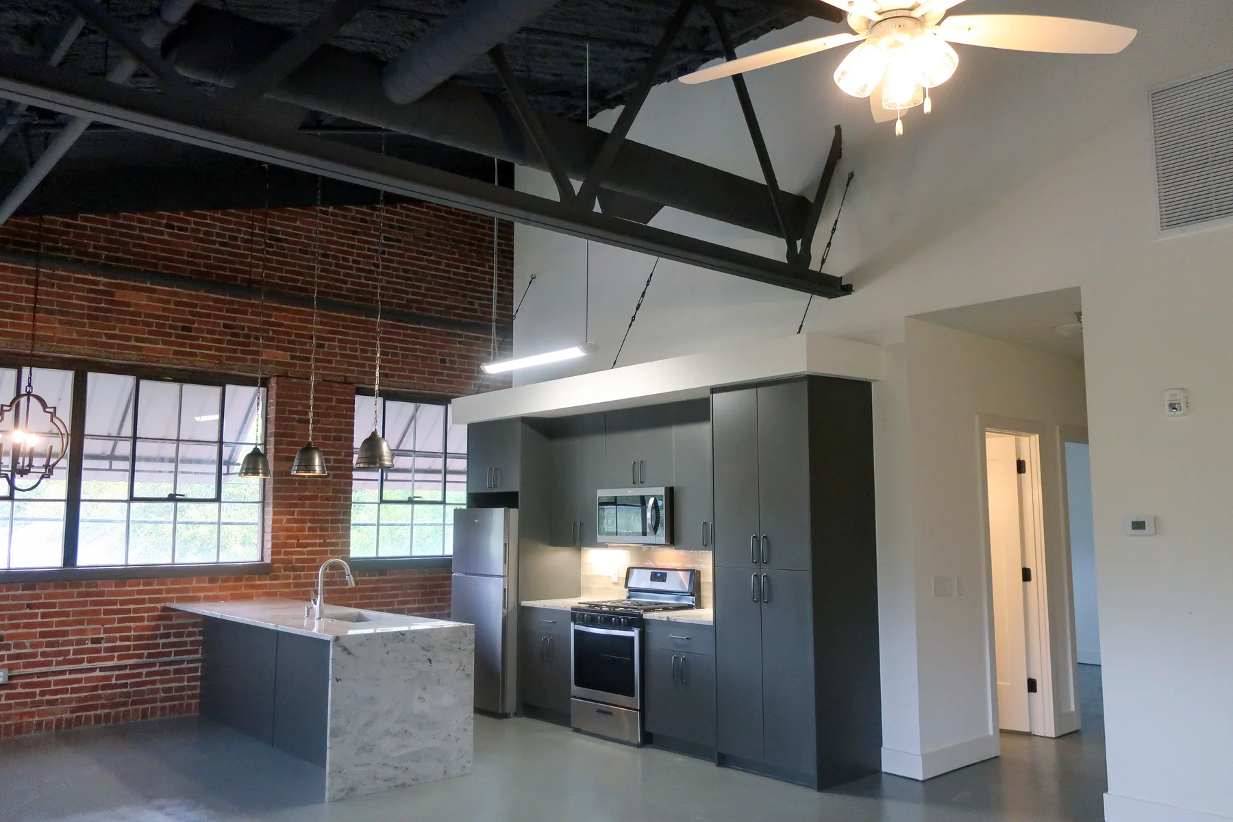 Loft kitchen beneath exposed roof structure at Liberty Lofts