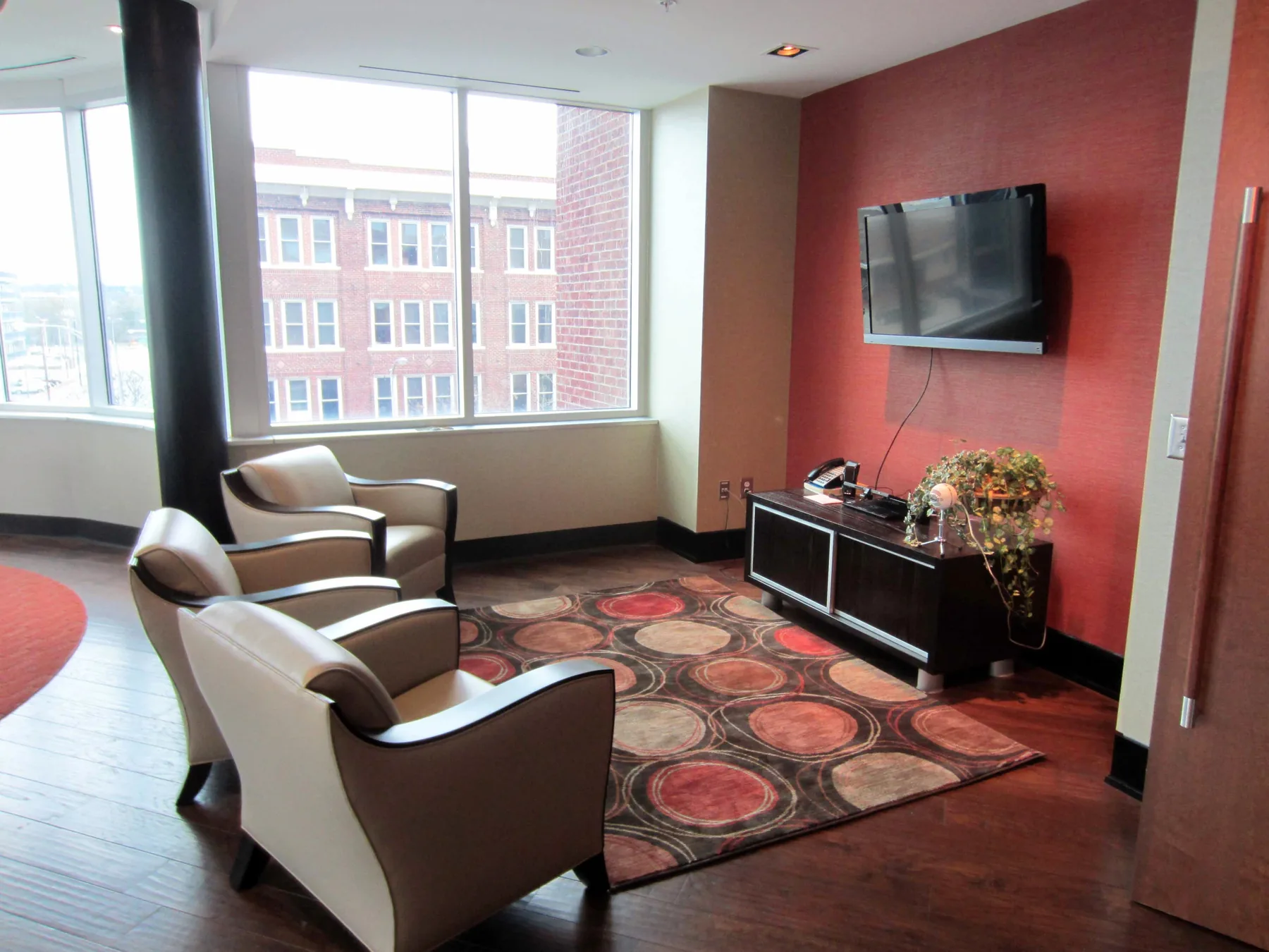 Red-walled office lounge inside Mauldin & Jenkins
