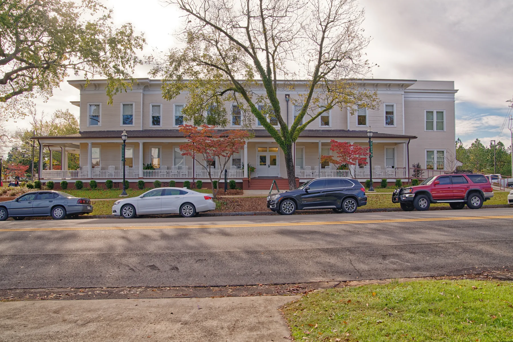 White two-story Mayfair Hall and its deep columned porch