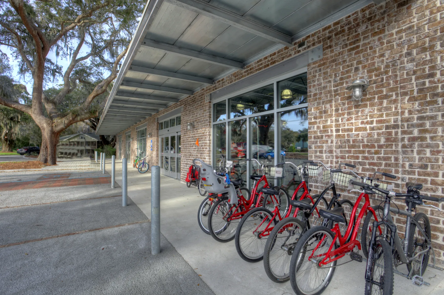 Covered brick Monkeywrench Bicycles storefront with bikes along the sidewalk