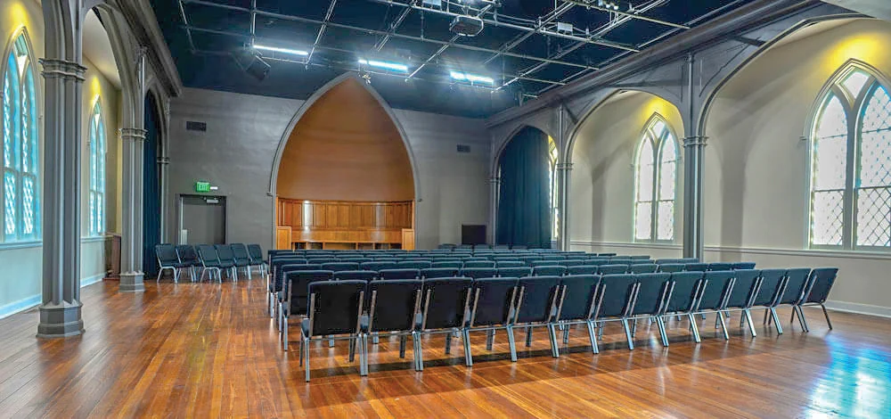 Restored sanctuary hall with gothic windows at the Tattnall Center